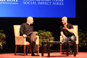 Andre Agassi and Bobby Turner sit on a stage in conversation