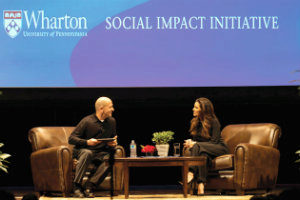 Eva Longoria and Bobby Turner sit on stage, in conversation