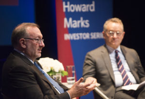 Howard Marks and Seth Klarman sit on a stage, in discussion