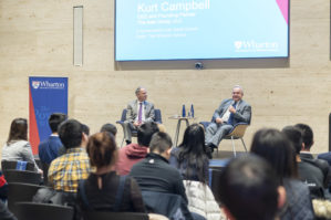 Kurt Campbell and Dean Geoff Garrett sitting on a stage holding microphones in conversation